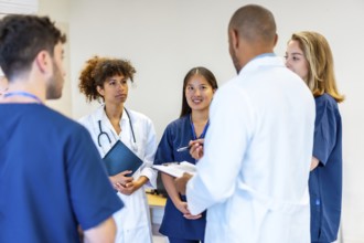 Diverse medical professionals collaborating, sharing expertise, and reviewing patient information