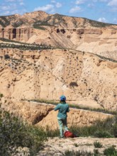 Cyclist looks over the desert, viewpoint, Gorafe Desert, UNESCO Granada Geopark, Granada province,