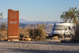 Signpost at the Gorafe megalithic park, camper van, Gorafe desert, Andalusia, Spain