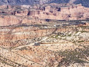 4x4 camper van driving on gravel road, Gorafe desert, colorful canyons, rock formations, Gorafe