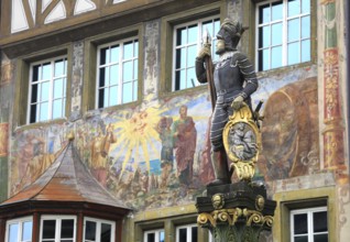 Soldier figure on the market fountain, house facade with facade painting in the old town, Stein am