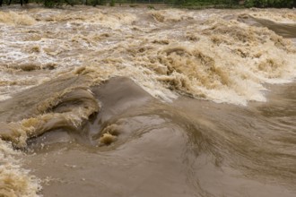 Symbolic image extreme weather, global warming, climate change, flood, flooded weir in Remseck an