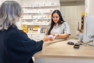 Rear view of a mature caucasian woman shopping in a modern pharmacy store