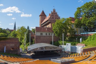 Medieval castle with open-air amphitheatre and surrounding trees, castle and amphitheatre, Olsztyn,