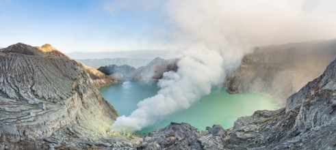 Volcano Kawah Ijen, volcanic craters with crater lake and steaming vents, morning light,