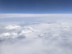 View from aeroplane at high altitude on almost closed cloud cover of white clouds Altostratus and