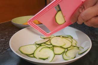Swabian cuisine, preparing courgettes for mini dinettes, slicing vegetables, vegetable slicer,