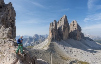 Hiker on the via ferrata to Patternkofel, Northern walls of the Three Peaks, Sesto Dolomites, South