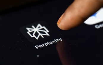 In this photo Illustration a person browsing taps perplexity app icon on a tablet device on 24 May