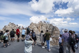 Tourists on the viewing platform at the summit of the Zugspitze, overtourism, mountain station of