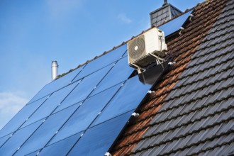 Solar panels and air conditioning on the roof of a detached house in Essen, Germany
