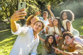 Multicultural young friends taking selfie enjoying a day in a park