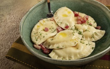 Dumplings, with fried prosciutto, a traditional dish of Polish cuisine, dumplings, top view,