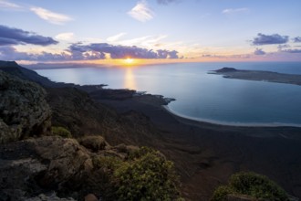 View from steep cliffs to sea and coast with sun stars, Mirador del Porrito viewpoint at sunset,