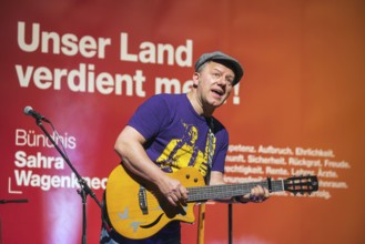 Tino Eisbrenner plays music on stage. Election event of the party Bündnis Sahra Wagenknecht for the