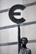 The bronze statue entitled Europe by May Claerhout holds up the euro symbol, Rue Wiertz, European