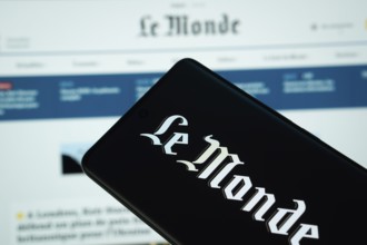 The logo of the newspaper le monde is displayed on a smartphone screen, and the website le monde is