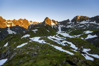 Rocky mountain peaks with snow, at the Trollfjord Hytta, mountain landscape with alpenglow at