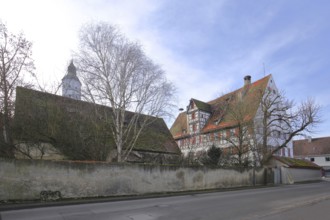 Historic office building built in 1610 with the tower of St Martin's Church, Langenau, Alb-Donau