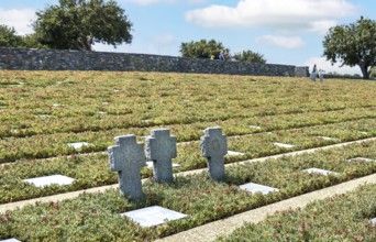 Three stone crosses between rows of grave slabs Gravestones Graves German soldiers' graves on part