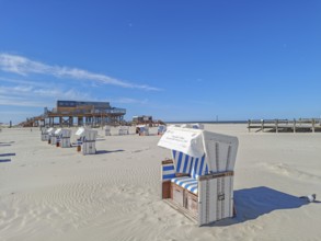 Preparing for the high season on the beach, setting up the beach chairs, North Sea, on the edge of