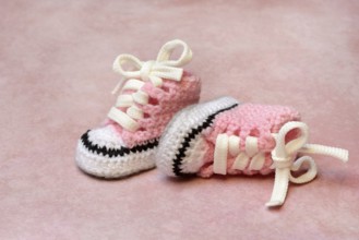 Baby shoes with pink background, handmade