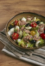 Salad with canned tuna, vegetable salad with quail eggs, lettuce, red onion, cherry tomatoes,