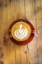 Cappuccino with floral pattern in milk foam, wooden table, coffee, cup, coffee mug, drink, caffeine