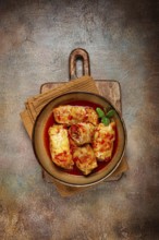 Stuffed cabbage rolls with minced meat, in tomato sauce, top view, without people, in the spotlight