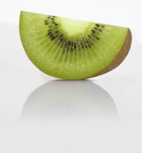 A quarter kiwi, kiwi fruit, Chinese gooseberry (Actinidia deliciosa) against a white background,