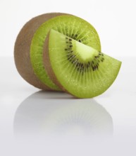 Half a kiwi and a kiwi slice, kiwi, kiwi fruit, Chinese gooseberry (Actinidia deliciosa) against a
