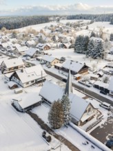 Snow-covered roofs and church in a wintry village, Oberreichenbach, Black Forest, Calw district,