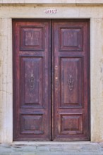 Door of an old house on 'Campo santa margherita' town square in Venice on a sunny day in winter,
