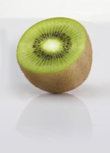 Half a kiwi, kiwi fruit, Chinese gooseberry (Actinidia deliciosa) against a white background,