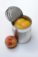 Peach, preserved peach halves with syrup in a tin can