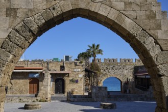 Arched wall overlooking the sea and historic buildings, Rhodes Old Town, Rhodes, Dodecanese, Greek