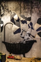 Banksy - Bad in Truemmern, painting on a destroyed house wall in Kiev, Ukraine, exhibition The