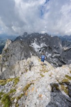 Mountaineer at the summit of the Ackerlspitze, view of rugged, rocky mountain landscape, view from
