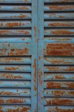 Weathered blue and red window shutter, mountain village Lakkoi, Crete, Greece