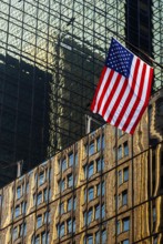 Reflections in glass facades, us national flag, stars stripes, Manhattan, New York City, USA