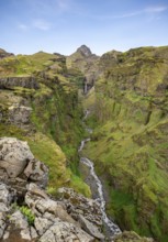 Mountain landscape with green canyon, waterfall and river in Múlagljúfur Canyon, Sudurland, Iceland