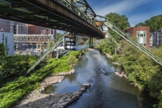 The Wuppertal suspension railway runs through a historic district and industrial area near the