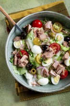 Salad with canned tuna, vegetable salad with quail eggs, lettuce, red onion, cherry tomatoes,