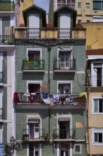 Residential building, house facade, narrow, azulejos, tiles, tile decoration, laundry for drying,