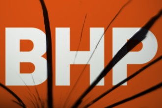 BHP logo is visible on the broken glass. BHP Group Limited is an Australian multinational mining