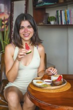 Young woman savoring a traditional filipino breakfast with watermelon, showcasing the vibrant
