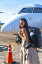 Young woman tourist with backpack arriving at francisco b. Reyes airport on coron island, ready to