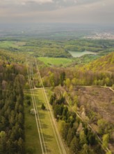 Hilly forest landscape with distant views of power lines and nature, Glems reservoir, Swabian Alb,