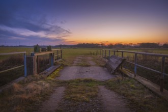 View of a sluice and a bridge with a pasture behind it at sunset, Kirchlinteln, Verden, Aller Leine