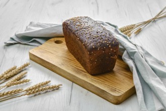 Loaf of brown sourdough bread with sunflower seeds and sesame